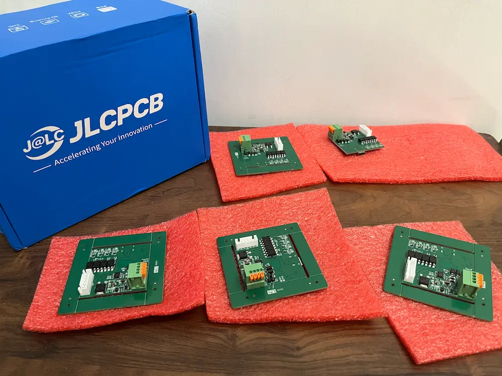 Batch of custom ESP32-S3 curtain controller boards, framed and frameless variants, unpacked from a JLCPCB shipping box