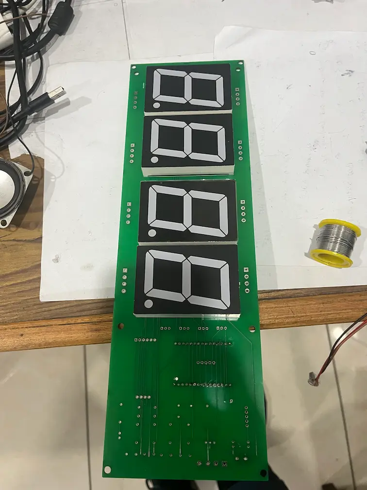 Custom PCB for the hoop alarm clock with four large two-digit 7-segment display modules mounted on the board